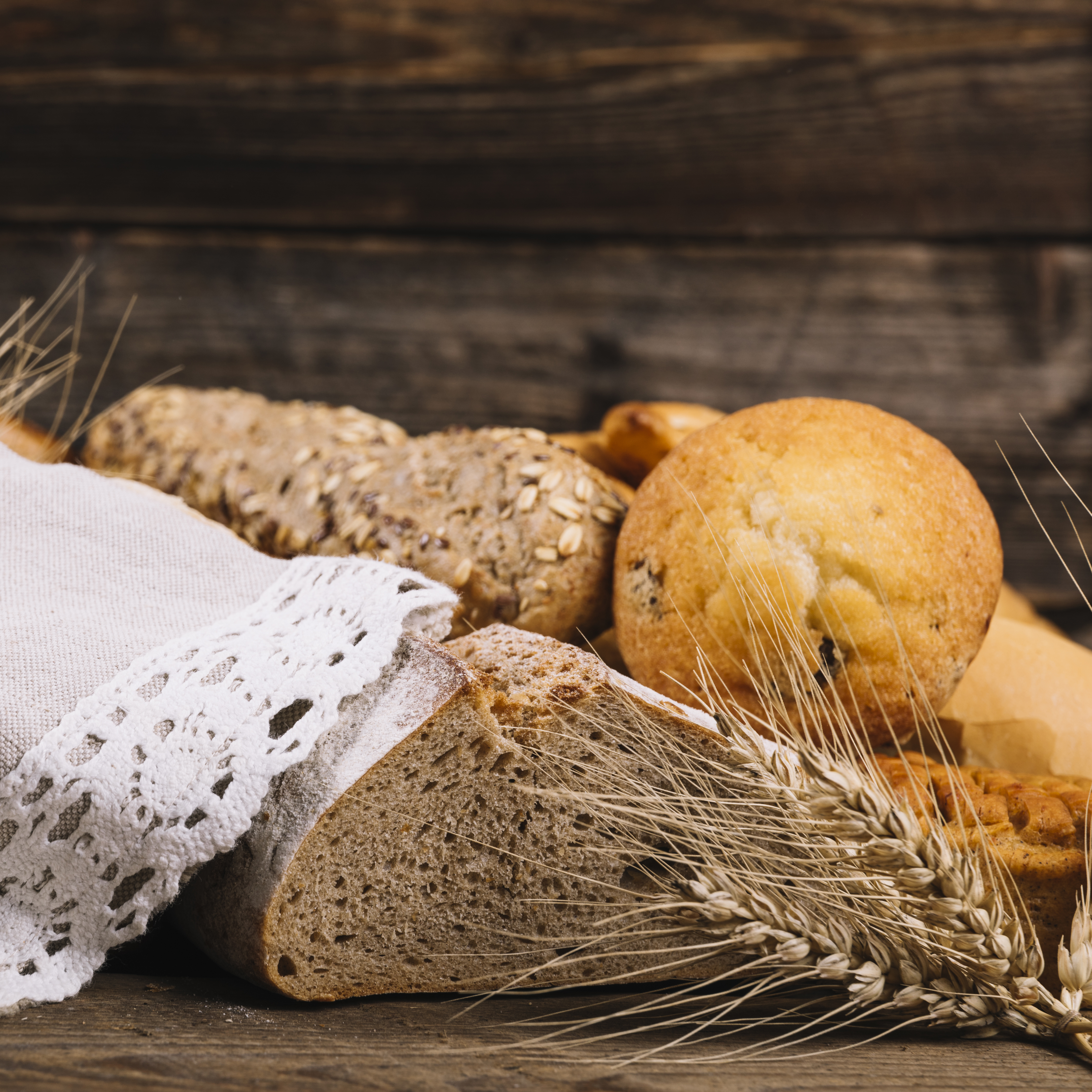 ear wheat with baked bread wooden table