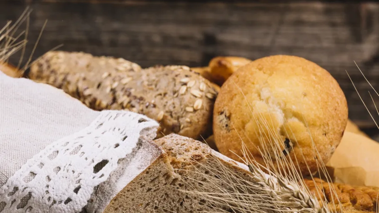 ear-wheat-with-baked-bread-wooden-table