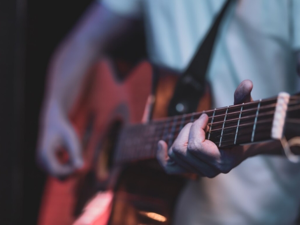 man-plays-acoustic-guitar-dark-room-live-performance-acoustic-concert_169016-10850